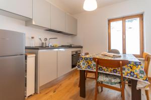 a kitchen with a table with a table cloth on it at Sweet Loft in Sottoguda