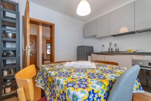 a kitchen with a table with a floral table cloth on it at Sweet Loft in Sottoguda +13 photos