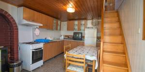 a small kitchen with a table and a stove at JOSIP A3 in Nerezine
