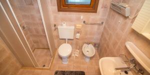 a small bathroom with a toilet and a sink at JOSIP A3 in Nerezine