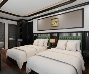 two beds in a hotel room with at Royal Hotel Lâm Hạ in Hanoi