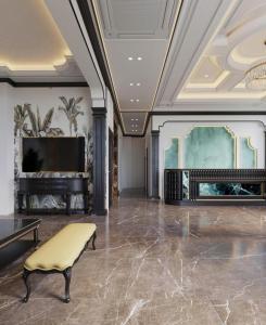 a living room with a tv and a couch and a chair at Royal Hotel Lâm Hạ in Hanoi