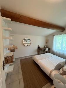 a bedroom with a large bed in a room at La Parenthèse Balnéo in Donzère