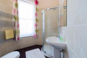 a bathroom with a sink and a toilet and a shower at Gazeley Manor House - Central Huntingdon in Huntingdon