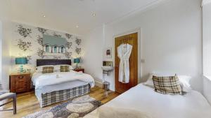 Ένα ή περισσότερα κρεβάτια σε δωμάτιο στο Finest Retreats - Garden Cottage at Ormidale House