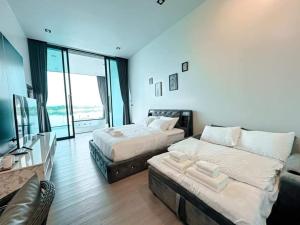 Ένα ή περισσότερα κρεβάτια σε δωμάτιο στο พูลวิลล่าริมโขง นครพนม