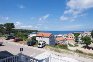 a town with cars parked in a parking lot at B&B sv. Martin in Mali Lošinj