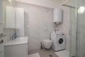 a white bathroom with a toilet and a washing machine at B&B sv. Martin in Mali Lošinj +54 photos