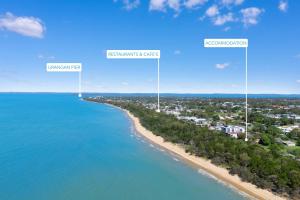 an aerial view of a beach with three tall white poles at Esplanade Charm Apartment in Torquay