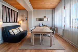 a living room with a table and a couch at White Lodges - Megève center on ski slopes in Megève