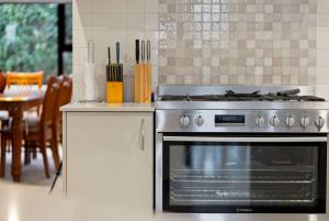 una cocina con estufa y una mesa con utensilios en Beautiful Spacious Home in a Serene Setting, en Eglinton