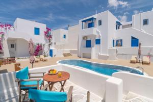 a villa with a pool and a table and chairs at Apollon Rooms 2 in Pollonia