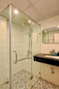 a bathroom with a shower and a sink at Hanoi Cozy Boutique Hotel in Hanoi