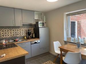 a kitchen with a refrigerator and a table with chairs at Möwennest in Timmendorfer Strand