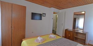 a bedroom with a bed with two pink pillows on it at Antunovic in Veli Lošinj