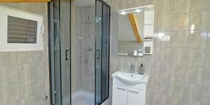 a bathroom with a shower and a sink at Antunovic in Veli Lošinj +51 photos