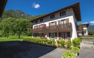 a large building with a balcony on top of it at Casa Lori Green Holiday in Ledro