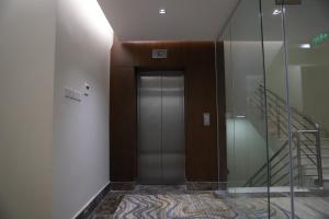 a hallway with a glass door and a staircase at Medhal qurtuba by Prime hotels in Riyadh