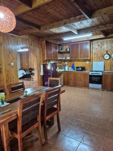 a large kitchen with a wooden table and chairs at Kitengela Farmhouse in Nairobi