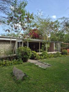 a house with a garden in front of it at Kitengela Farmhouse in Nairobi