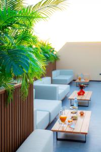 a room with couches and tables and plants at Residence Eden Marrakech in Marrakesh