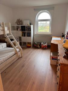 a bedroom with a bunk bed and a window at Gut Ellernwurth in Wurster Nordseeküste