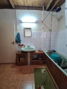 a bathroom with a sink and a tub at Kitengela Farmhouse in Nairobi +63 photos