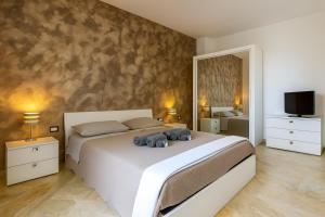 a bedroom with a bed with a teddy bear on it at Penthouse Station luxury apts Le dimore in Brindisi +25 photos