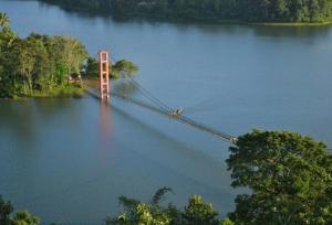un pont au milieu d'une grande masse d'eau dans l'établissement Jerusalem Home Saty, à Idukki