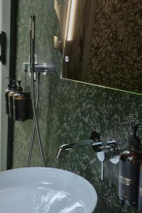 a bathroom with a white sink and a mirror at Namety Park in Kyiv