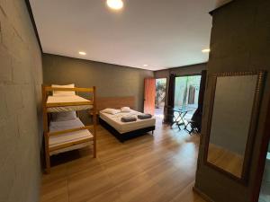 a room with a bunk bed and a mirror at Recanto Praia Grande in Arraial do Cabo