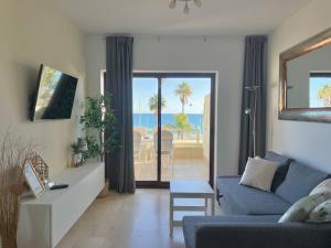 a living room with a couch and a view of the ocean at Luxury, Frontline Burriana Beach, Nerja in Nerja