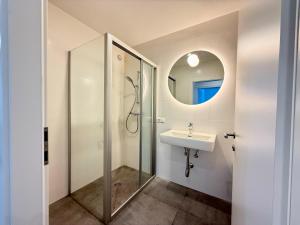 a bathroom with a sink and a mirror at Treehouse - Alpinlake Apartments in Grünau im Almtal