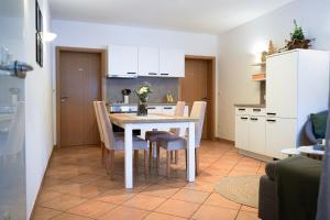a kitchen with a table and chairs in a room at Restaurant - Garni bei Peppo in Ebern