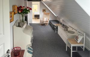a room with a staircase with a couch and a table at 7 Bedroom Stunning Home In Samsø in Kolby Kås