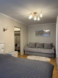 a bedroom with two beds and a couch at Loading Apartments in Chernivtsi