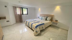 a bedroom with a bed in a white room at Le Paradisblanc in Kelibia +182 photos
