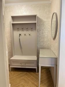 a bathroom with a dressing table and a mirror at Loading Apartments in Chernivtsi