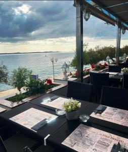 a restaurant with tables and a view of the water at Villa Nico in Zadar