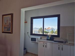 a kitchen with a sink and a window with a view at Sabbia Suites Casa Vera in Teguise +6 photos