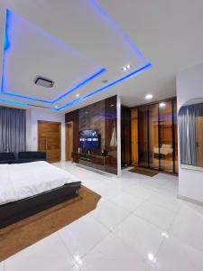 a bedroom with a bed and a tv in it at Casa Lumière in Lekki