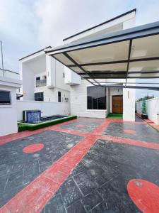 a large white building with a red stripe on the ground at Casa Lumière in Lekki