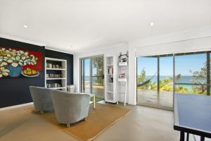 a living room with a view of the ocean at Sticks by the Sea - pet-friendly coastal home in Manyana