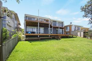 an exterior view of a house with a yard at Sticks by the Sea - pet-friendly coastal home in Manyana