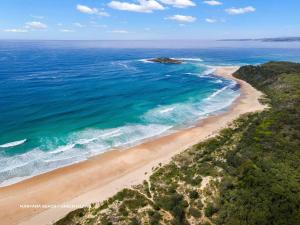 an aerial view of a beach and the ocean at Sticks by the Sea - pet-friendly coastal home in Manyana