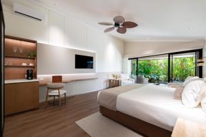 a bedroom with a bed and a kitchen and a tv at NALA Resort in Mission Beach +26 photos
