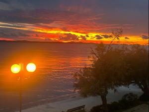 a sunset over a body of water with a street light at Villa Nico in Zadar +51 photos