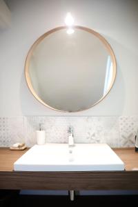 a bathroom sink with a large mirror above it at LE CEDRE Maison bord de LOIRE 4 in Muides-sur-Loire +52 photos