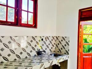 a kitchen counter with a sink and a window at Yala Eagle Nest in Tissamaharama +31 photos