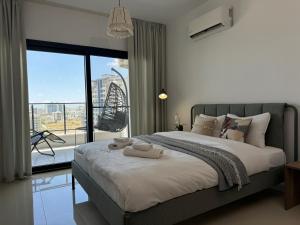 a bedroom with a bed with two towels on it at Seaview stylish one bedroom apartment in Caesar Romulus 88 in Bahçeler